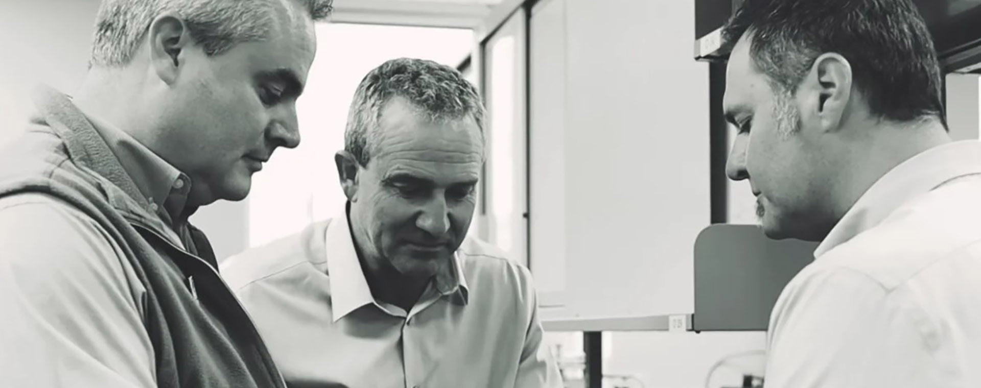 three men in lab experts