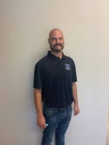 Technical Account Manager Curt Sotera standing in front of a white wall.